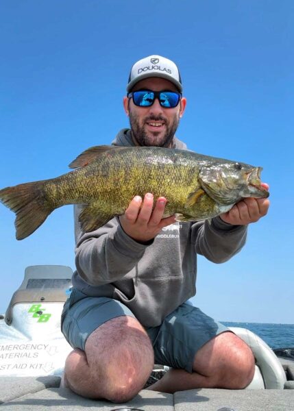 Captain Tyler Smith with a 6 pound 10 ounce Lake St. Clair smallmouth bass.