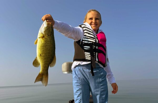 Happy girl with smallmouth bass