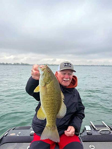 Huk man with smallmouth bass 480img0964