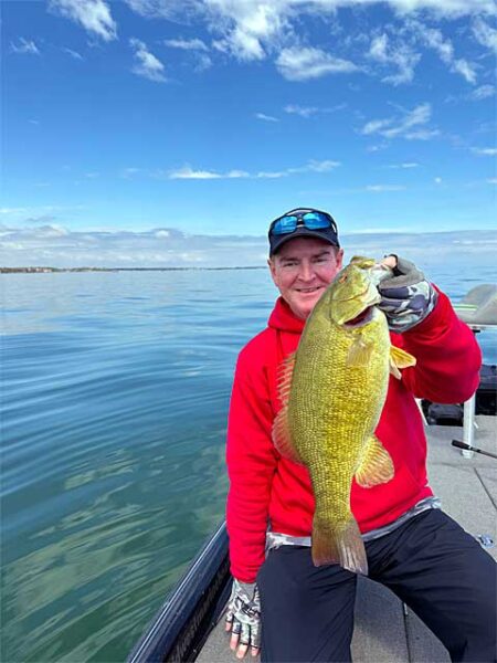 Man in red fat smallmouth bass img0959
