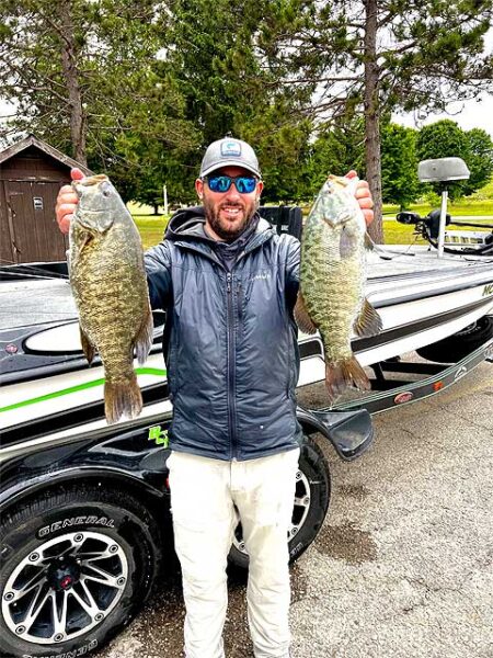 Tyler with 2 big smallmouth bass img5321