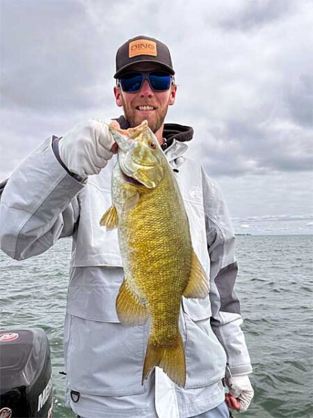 Young angler with smallmouth bass img1010